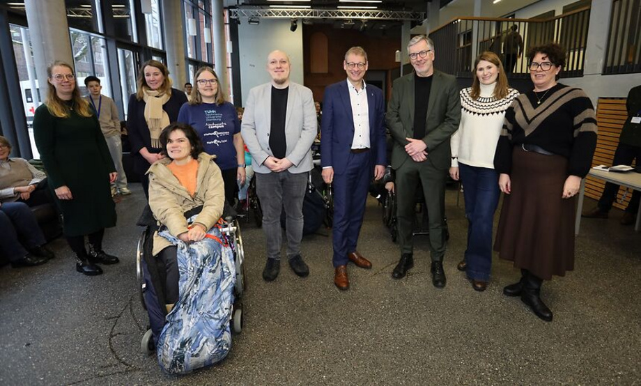 a group of people, one woman in a wheelchair